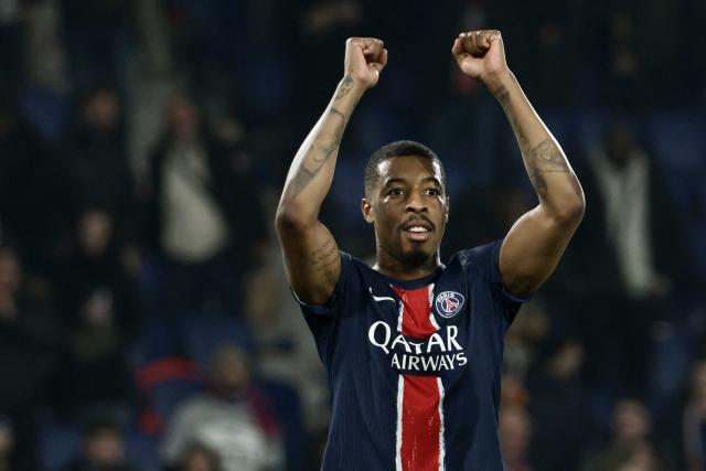 (FILES) Paris Saint-Germain's French defender #03 Presnel Kimpembe celebrates PSG's victory at the end of the UEFA Champions League knockout phase play-off 2nd leg football match between Paris Saint-Germain (FRA) and Brest (FRA) at the Parc des Princes stadium in Paris on February 19, 2025. The 2018 World Cup winner Presnel Kimpembe, former captain of Paris SG, has signed for the Qatari second-tier club Al-Kharaitiyat, his new club has announced. (Photo by Thibaud MORITZ / AFP)