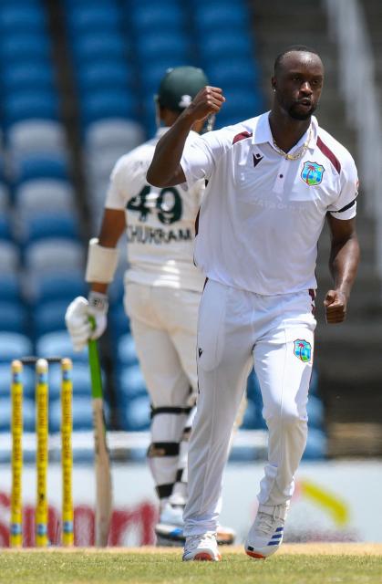 Kemar Roach (R) of West Indies celebrates the dismissal of Khurram Shahzad (L) of Pakistan during the third day of the first Test cricket match between West Indies and Pakistan at the Brian Lara Cricket Academy in Tarouba, Trinidad and Tobago, on July 27, 2026. (Photo by Randy Brooks / AFP)