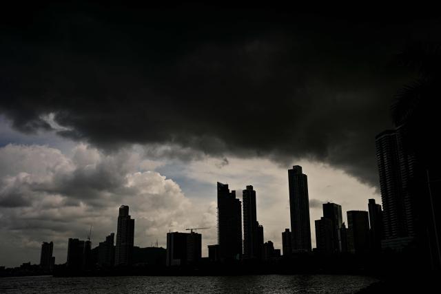 Storm clouds gather over the skyline of Panama City during a thunderstorm on July 27, 2026. (Photo by MARTIN BERNETTI / AFP)