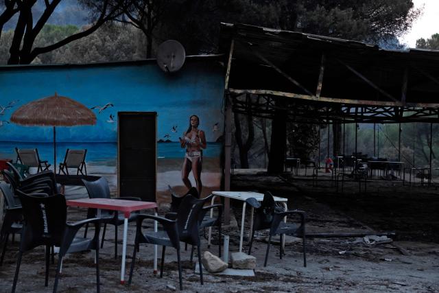 View of the burned bar at the San Juan Reservoir after a wildfire in Pelayos de la Presa, Madrid Community, Spain, in July 27, 2026. Spain faces two crucial days to bring raging wildfires under control before weather conditions worsen, authorities said on July 27, 2026, though they were making some progress and planned to start returning evacuees to certain areas. The fires in the Iberian country have affected an area of 77,000 hectares (190,000 acres) -- nearly the size of New York City -- according to the authorities. Since the start of the year, fires in Spain have ravaged 150,000 hectares and killed 13 people. (Photo by Oscar DEL POZO / AFP)
