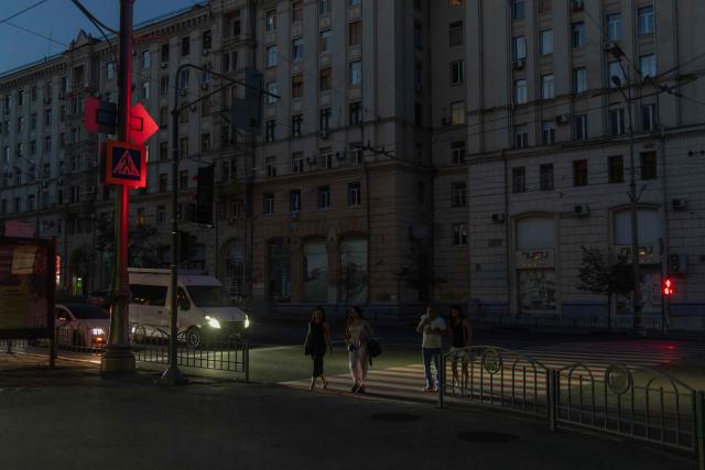 People cross a road in the eastern city of Kharkiv on July 27, 2026, amid the Russian invasion of Ukraine. (Photo by Roman PILIPEY / AFP)