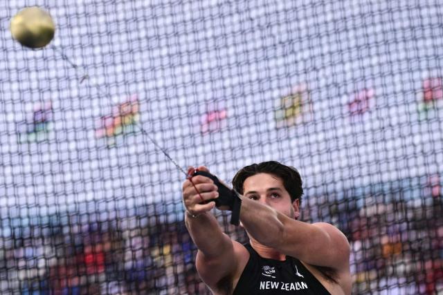 New Zealand's Anthony Barmes competes in the men's hammer throw final during the athletics event at the Scotstoun Stadium in Glasgow, on day four of the Commonwealth Games in Glasgow, Scotland, on July 27, 2026. (Photo by Ben STANSALL / AFP)