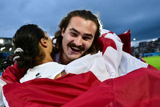 Winner Canada's Ethan Katzberg (R) celebrates with third-placed Canada's Rowan Hamilton (L) after competing in the men's hammer throw final during the athletics event at the Scotstoun Stadium in Glasgow, on day four of the Commonwealth Games in Glasgow, Scotland, on July 27, 2026. (Photo by Ben STANSALL / AFP)