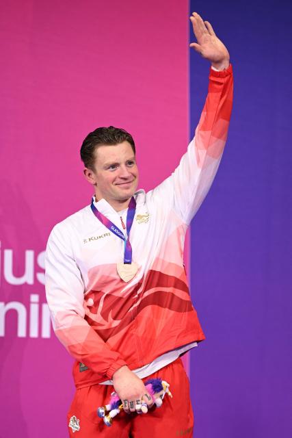 Bronze medallist England's Adam Ramsay-Peaty reacts during the Men's 50m Breaststroke Medal Ceremony at the swimming event at the Tollcross International Swimming Centre in Glasgow, on day four of the Commonwealth Games in Glasgow, Scotland, on July 27, 2026. (Photo by Oli SCARFF / AFP)