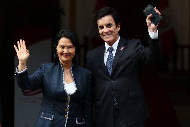Peru's President-elect Keiko Fujimori (L) and appointed Foreign Minister Carlo Espa wave as they wait for foreign delegations arriving at the Foreign Ministry for bilateral meetings ahead of Fujimori's inauguration in Lima on July 27, 2026. (Photo by Connie FRANCE / AFP)