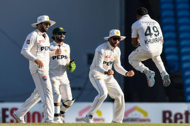 Bowler Khurram Shahzad of Pakistan celebrates with teammates Azan Awais (L), wicketkeeper Mohammad Rizwan (C-L) and Salman Ali Agha after batsman Roston Chase of West Indies (unseen) was caught behind for 8 runs during the third day of the first Test cricket match between West Indies and Pakistan at the Brian Lara Cricket Academy in Tarouba, Trinidad and Tobago, on July 27, 2026. (Photo by Randy Brooks / AFP)