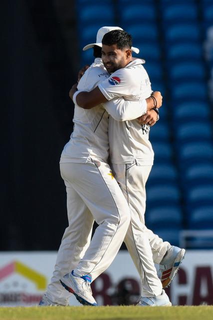 Bowler Khurram Shahzad of Pakistan celebrates with teammate Salman Ali Agha (L) after taking the wicket of batsman Roston Chase of West Indies (unseen) for 8 runs during the third day of the first Test cricket match between West Indies and Pakistan at the Brian Lara Cricket Academy in Tarouba, Trinidad and Tobago, on July 27, 2026. (Photo by Randy Brooks / AFP)