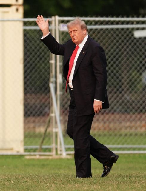 US President Donald Trump waves after stepping off Marine One upon landing on the Ellipse near the White House in Washington, DC, on July 27, 2026. Trump is returning  from Milford, Michigan where he visited General Motors' vehicle testing site Milford Proving Ground. (Photo by Aaron Schwartz / AFP)