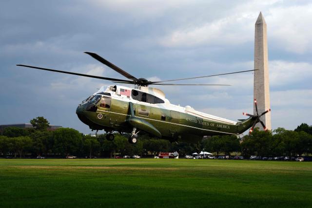 A US Marine Corps helicopter, commonly known as "White Tops", used in support of Marine One, takes off after the arival of US President Donald Trump into the Ellipse near the White House in Washington, DC, on July 27, 2026. Trump returned from Milford, Michigan where he visited General Motors' vehicle testing site Milford Proving Ground. (Photo by Aaron Schwartz / AFP)