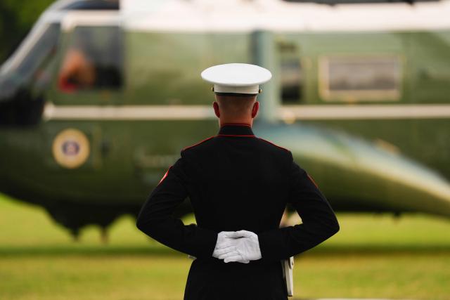 A US Marine Sentry stands guard after Marine One with US President Donald Trump on board, landed in the Ellipse near the White House in Washington, DC, on July 27, 2026. Trump returned from Milford, Michigan where he visited General Motors' vehicle testing site Milford Proving Ground. (Photo by Aaron Schwartz / AFP)