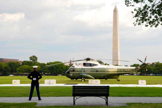 A US Marine Sentry stands guard after Marine One with US President Donald Trump on board, landed in the Ellipse near the White House in Washington, DC, on July 27, 2026. Trump returned from Milford, Michigan where he visited General Motors' vehicle testing site Milford Proving Ground. (Photo by Aaron Schwartz / AFP)