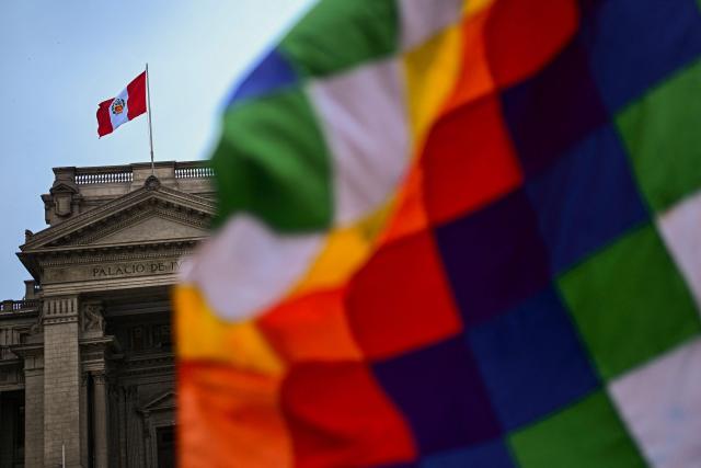 A Wiphala flag is seen during a vigil by relatives of victims of crimes allegedly committed by the Peruvian state outside the Palace of Justice in Lima on July 27, 2026. (Photo by Ernesto BENAVIDES / AFP)