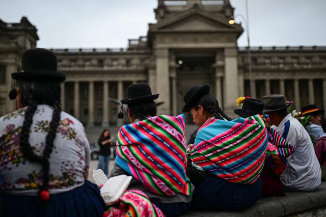 Relatives of victims of crimes allegedly committed by the Peruvian state take part in a vigil outside the Palace of Justice in Lima on July 27, 2026. (Photo by Ernesto BENAVIDES / AFP)