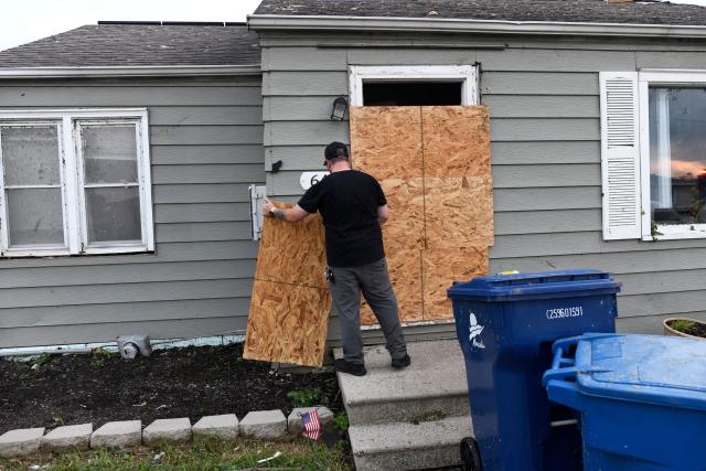 A man makes repairs to his house after a tornado ripped through parts of Wisconsin in Menasha, Wisconsin, on July 27, 2026. (Photo by OCTAVIO JONES / AFP)