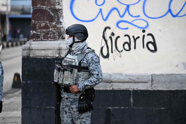 A National Guard member stands guard at the crime scene where one man was killed and two others were wounded in an armed attack at Plaza de Santo Domingo in Mexico City's historic center on July 27, 2026. A broad-daylight shooting in Mexico City left one person dead and two others injured just a few blocks from Mexico City's central Zocalo square and the presidential palace, where President Claudia Sheinbaum works and resides. (Photo by Yuri CORTEZ / AFP)
