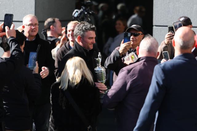 New Zealand golfer Ryan Fox (C) carries the Open Championship Claret Jug trophy as he arrives for a public event in Auckland on July 28, 2026. Fox returned to New Zealand for a public celebration at Takutai Square in Auckland after winning the (British) Open Championship at the Royal Birkdale golf course in England on July 19. (Photo by Ben STRANG / AFP)