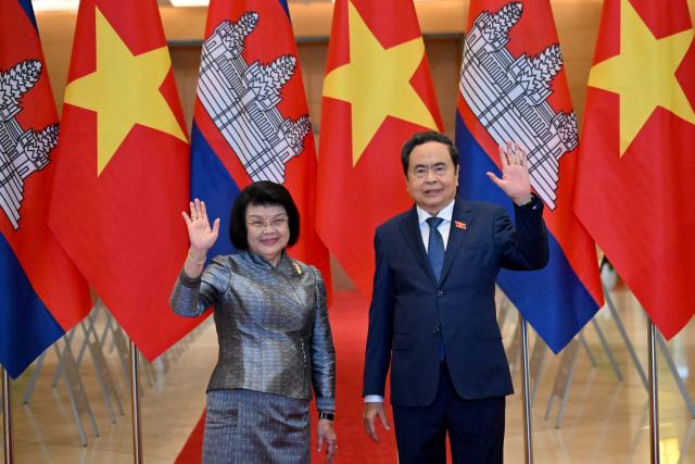 Vietnam's National Assembly Chairman Tran Thanh Man (R) and Cambodia's National Assembly Chairman Samdech Khuon Sudary wave during a welcome ceremony at the National Assembly in Hanoi on July 28, 2026. (Photo by Nhac NGUYEN / AFP)
