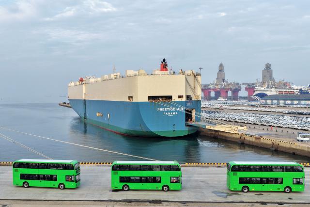 Yutong electric double-decker buses for export to the UK are driven onto a car carrier at Yantai Port in Shandong province, eastern China on July 27, 2026. (Photo by CN-STR / AFP) / China OUT