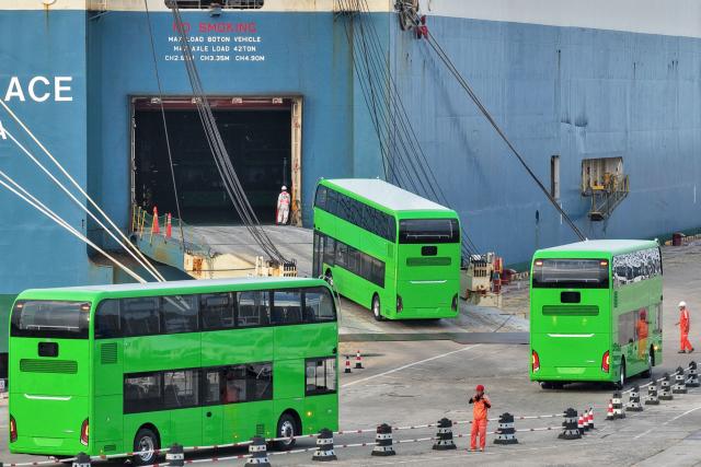 Yutong electric double-decker buses for export to the UK are driven onto a car carrier at Yantai Port in Shandong province, eastern China on July 27, 2026. (Photo by CN-STR / AFP) / China OUT