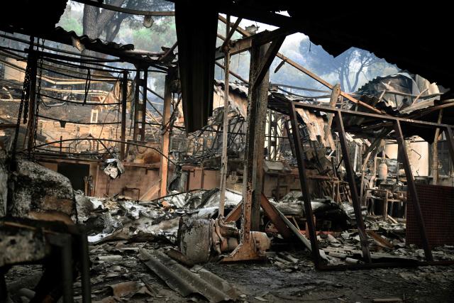 View of the damage in a boat rental facility in San Juan reservoir after a wildfire ravaged the region in Pelayos de la Presa, 65 kilometres southwest of Madrid, in July 28, 2026. Firefighters in Spain made progress after a "positive night" against wildfires raging west of Madrid that have forced the evacuation of tens of thousands of people, Interior Minister Fernando Grande-Marlaska said today. Spain's government declared a national emergency last week over some of the worst wildfires in the country's history raging in fronts across the Madrid region, Avila province, Toledo and eastern Valencia. (Photo by Miguel RIOPA / AFP)