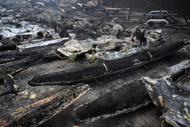 Charred pedalo boats are seen at the San Juan Reservoir after a wildfire ravaged the region in Pelayos de la Presa, 65 kilometres southwest of Madrid, in July 28, 2026. Firefighters in Spain made progress after a "positive night" against wildfires raging west of Madrid that have forced the evacuation of tens of thousands of people, Interior Minister Fernando Grande-Marlaska said today. Spain's government declared a national emergency last week over some of the worst wildfires in the country's history raging in fronts across the Madrid region, Avila province, Toledo and eastern Valencia. (Photo by Miguel RIOPA / AFP)