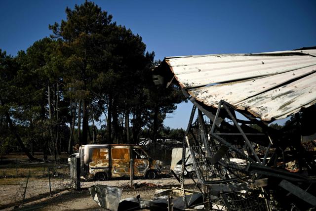 This photograph shows burnt vehicles in a business park following a wildfire in Biscarrosse, southwestern France on July 28, 2026. The fire that broke out on July 23, 2026, near Biscarrosse in the Landes region of southwestern France has been "contained," France's President announced on July 27.
The Landes de Gascogne forest, home to maritime pines and a vital "lung" for the timber industry, has seen 42,000 hectares burn near Bordeaux. Forests are catching fire all the more easily because European vegetation and soils have been very dry for monthsa drought exacerbated by climate change and recent exceptional heatwaves. (Photo by Philippe Lopez / AFP)
