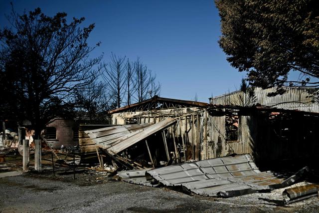 This photograph shows the burnt building of a company in a business park following a wildfire in Biscarrosse, southwestern France on July 28, 2026. The fire that broke out on July 23, 2026, near Biscarrosse in the Landes region of southwestern France has been "contained," France's President announced on July 27.
The Landes de Gascogne forest, home to maritime pines and a vital "lung" for the timber industry, has seen 42,000 hectares burn near Bordeaux. Forests are catching fire all the more easily because European vegetation and soils have been very dry for monthsa drought exacerbated by climate change and recent exceptional heatwaves. (Photo by Philippe Lopez / AFP)