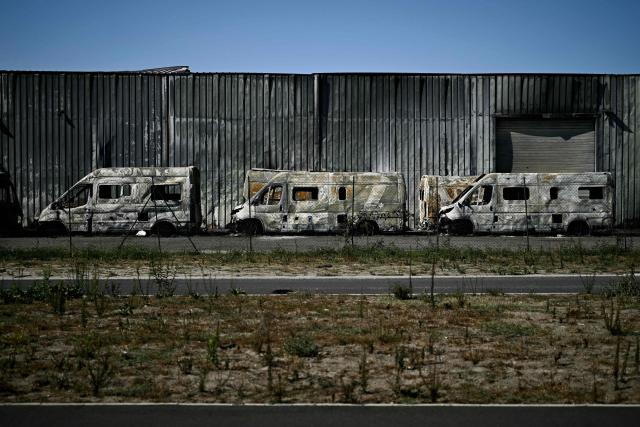 This photograph shows burnt vehicles in a business park following a wildfire in Biscarrosse, southwestern France on July 28, 2026. The fire that broke out on July 23, 2026, near Biscarrosse in the Landes region of southwestern France has been "contained," France's President announced on July 27.
The Landes de Gascogne forest, home to maritime pines and a vital "lung" for the timber industry, has seen 42,000 hectares burn near Bordeaux. Forests are catching fire all the more easily because European vegetation and soils have been very dry for monthsa drought exacerbated by climate change and recent exceptional heatwaves. (Photo by Philippe Lopez / AFP)