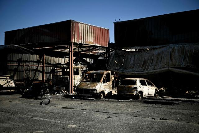 This photograph shows burnt vehicles of a professional or utility vehicle shop in a business park following a wildfire in Biscarrosse, southwestern France on July 28, 2026. The fire that broke out on July 23, 2026, near Biscarrosse in the Landes region of southwestern France has been "contained," France's President announced on July 27.
The Landes de Gascogne forest, home to maritime pines and a vital "lung" for the timber industry, has seen 42,000 hectares burn near Bordeaux. Forests are catching fire all the more easily because European vegetation and soils have been very dry for monthsa drought exacerbated by climate change and recent exceptional heatwaves. (Photo by Philippe Lopez / AFP)