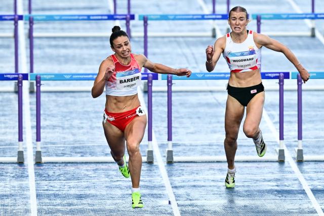 England's Ellen Barber (L) and Jersey's Lucy Woodward compete in the women's heptathlon 100m hurdles heat 1 during the athletics event at the Scotstoun Stadium in Glasgow, on day five of the Commonwealth Games in Glasgow, Scotland, on July 28, 2026. (Photo by Ben STANSALL / AFP)