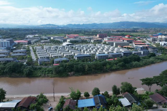(FILES) This aerial photo taken on September 17, 2025 shows the KK Park complex, then a scam hub in Myanmar's eastern Myawaddy township, as pictured from Mae Sot district in Thailand's border province of Tak. Myanmar's military-backed parliament approved a law on July 28, 2026 authorising capital punishment for those who detain or violently coerce victims into working in online scam centres. (Photo by Lillian SUWANRUMPHA / AFP)