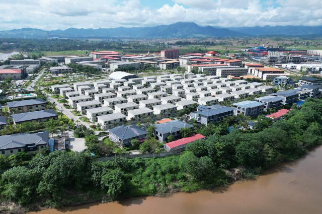 (FILES) This aerial photo taken on September 17, 2025 shows the KK Park complex, then a scam hub in Myanmar's eastern Myawaddy township, as pictured from Mae Sot district in Thailand's border province of Tak. Myanmar's military-backed parliament approved a law on July 28, 2026 authorising capital punishment for those who detain or violently coerce victims into working in online scam centres. (Photo by Lillian SUWANRUMPHA / AFP)