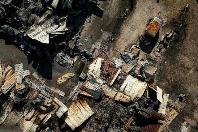 This aerial photograph shows burnt premisses and vehicles destroyed by a wildfire in a business park in Biscarrosse, southwestern France on July 28, 2026. The fire that broke out on July 23, 2026, near Biscarrosse in the Landes region of southwestern France has been "contained," France's President announced on July 27.
The Landes de Gascogne forest, home to maritime pines and a vital "lung" for the timber industry, has seen 42,000 hectares burn near Bordeaux. Forests are catching fire all the more easily because European vegetation and soils have been very dry for monthsa drought exacerbated by climate change and recent exceptional heatwaves. (Photo by Philippe Lopez / AFP)