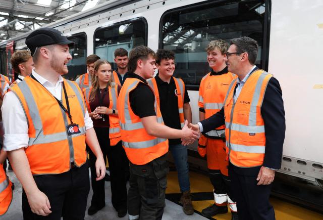 Britain's Prime Minister Andy Burnham meets young people, as he visits French run rail transport systems manufacturer Alstom in Derby, central England on July 28, 2026, on the day he unveils new technical educational routes aimed at tackling youth unemployment. (Photo by Temilade Adelaja / POOL / AFP)