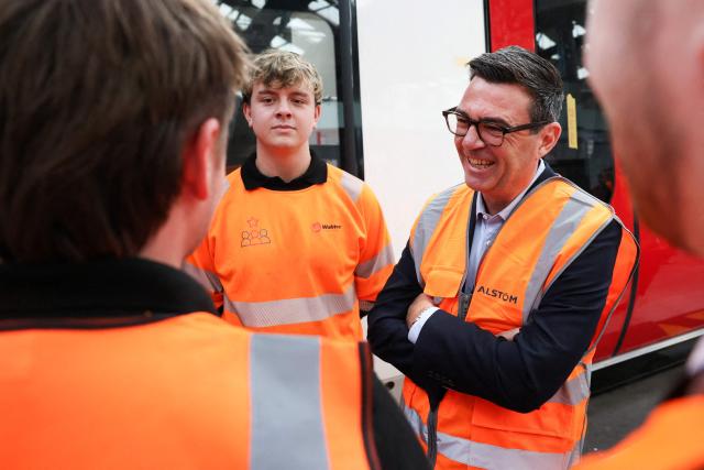 Britain's Prime Minister Andy Burnham meets young people, as he visits French run rail transport systems manufacturer Alstom in Derby, central England on July 28, 2026, on the day he unveils new technical educational routes aimed at tackling youth unemployment. (Photo by Temilade Adelaja / POOL / AFP)