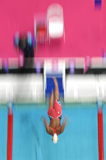 Grenada's Tilly Collymore dives into the pool as she competes in the Women's 50m Freestyle - Heats at the swimming event at the Tollcross International Swimming Centre in Glasgow, on day five of the Commonwealth Games in Glasgow, Scotland, on July 28, 2026. (Photo by Oli SCARFF / AFP)
