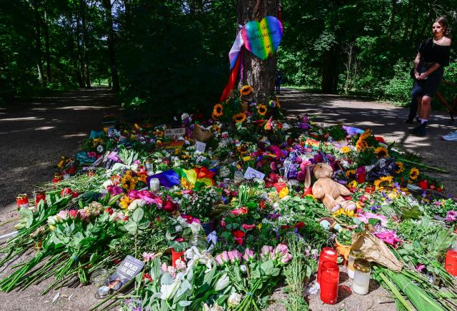 Flowers, candles and a sign with the lettering 'For the victims- for us' have been placed at a makeshift memorial in tribute to the victims at the Tiergarten park in Berlin on July 28, 2026, three days after a car ramming attack that killed one person and injured 29 near the Christopher Street Day (CSD) parade. German police had shot and killed the chief suspect in what officials described as a deadly Islamist attack near the Berlin Pride parade the night prior, the latest ramming assault to hit the country. The attack late on July 25 -- the first such incident to target the German capital's LGBTQ community, killed one woman and wounded 29 others. (Photo by John MACDOUGALL / AFP)