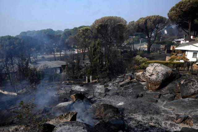 This picture shows scorched areas following a wildfire in Pelayos de la Presa, 65 kilometres south-west of Madrid, on July 28, 2026. Firefighters in Spain made progress after a "positive night" against wildfires raging west of Madrid that have forced the evacuation of tens of thousands of people, Interior Minister Fernando Grande-Marlaska said today. Spain's government declared a national emergency last week over some of the worst wildfires in the country's history raging in fronts across the Madrid region, Avila province, Toledo and eastern Valencia. (Photo by Miguel RIOPA / AFP)