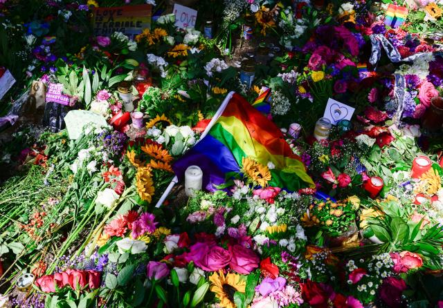 Flowers, candles and a rainbow flag have been placed at a makeshift memorial in tribute to the victims at the Tiergarten park in Berlin on July 28, 2026, three days after a car ramming attack that killed one person and injured 29 near the Christopher Street Day (CSD) parade. German police had shot and killed the chief suspect in what officials described as a deadly Islamist attack near the Berlin Pride parade the night prior, the latest ramming assault to hit the country. The attack late on July 25 -- the first such incident to target the German capital's LGBTQ community, killed one woman and wounded 29 others. (Photo by John MACDOUGALL / AFP)