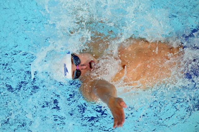 Scotland's Matthew Ward competes in the Men's 100m Backstroke - Heats at the swimming event at the Tollcross International Swimming Centre in Glasgow, on day five of the Commonwealth Games in Glasgow, Scotland, on July 28, 2026. (Photo by Oli SCARFF / AFP)