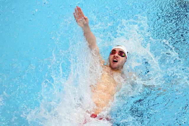 Cayman Islands' Luke Higgo competes in the Men's 100m Backstroke - Heats at the swimming event at the Tollcross International Swimming Centre in Glasgow, on day five of the Commonwealth Games in Glasgow, Scotland, on July 28, 2026. (Photo by Oli SCARFF / AFP)