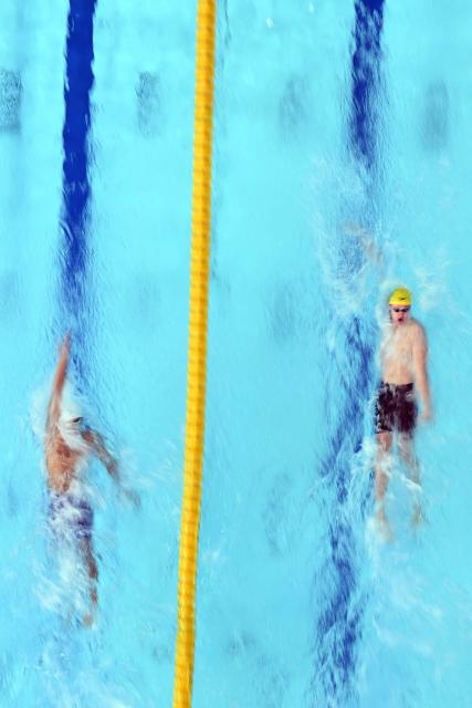 India's Srihari Nataraj (L) and Australia's Henry Allan compete in the Men's 100m Backstroke - Heats at the swimming event at the Tollcross International Swimming Centre in Glasgow, on day five of the Commonwealth Games in Glasgow, Scotland, on July 28, 2026. (Photo by Oli SCARFF / AFP)