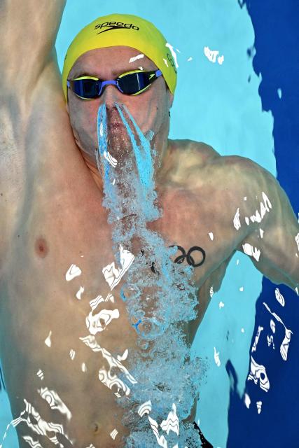 Australia's Isaac Cooper competes in the Men's 100m Backstroke - Heats at the swimming event at the Tollcross International Swimming Centre in Glasgow, on day five of the Commonwealth Games in Glasgow, Scotland, on July 28, 2026. (Photo by Oli SCARFF / AFP)
