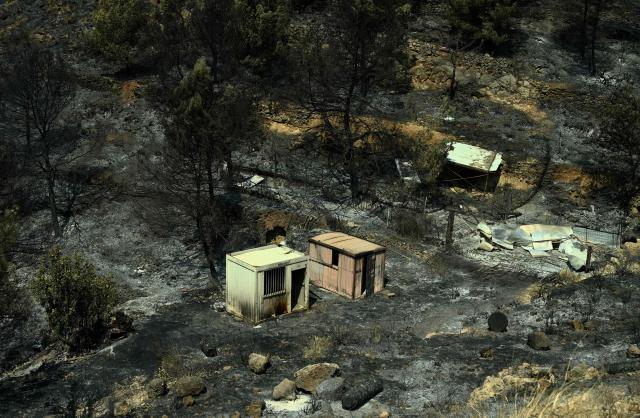 This picture shows a scorched area after a wildfire raged in La Vall d'Uixo, 55 kilometres north-east of Valencia, on July 28, 2026. Firefighters in Spain made progress after a "positive night" against wildfires raging west of Madrid that have forced the evacuation of tens of thousands of people, Interior Minister Fernando Grande-Marlaska said today. Spain's government declared a national emergency last week over some of the worst wildfires in the country's history raging in fronts across the Madrid region, Avila province, Toledo and eastern Valencia. (Photo by Jose JORDAN / AFP)