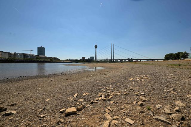 The partially dried-up river bed of the Rhine is pictured in Duesseldorf, western Germany, on July 28, 2026, following exceptionally hot weather. (Photo by Ina FASSBENDER / AFP)