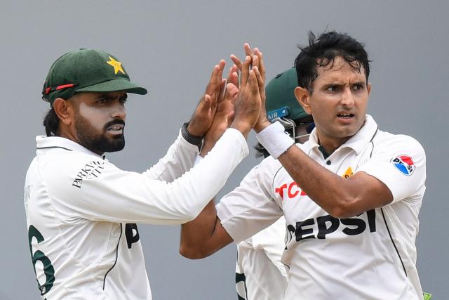 Mohammad Abbas (R) and Babar Azam (L) of Pakistan celebrate the dismissal of Jomel Warrican of West Indies  during the fourth day of the first Test cricket match between West Indies and Pakistan at the Brian Lara Cricket Academy in Tarouba, Trinidad and Tobago, on July 28, 2026. (Photo by Randy Brooks / AFP)