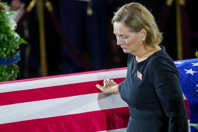 US Senator Darline Graham touches the casket as she pays her respects during a Congressional tribute to late US Senator Lindsey Graham in the Rotunda the US Capitol in Washington, DC, on July 28, 2026. Graham, a South Carolina Republican and key Trump ally who was elected to the Senate four times, died at age 71 on July 11. (Photo by Nathan Howard / POOL / AFP)