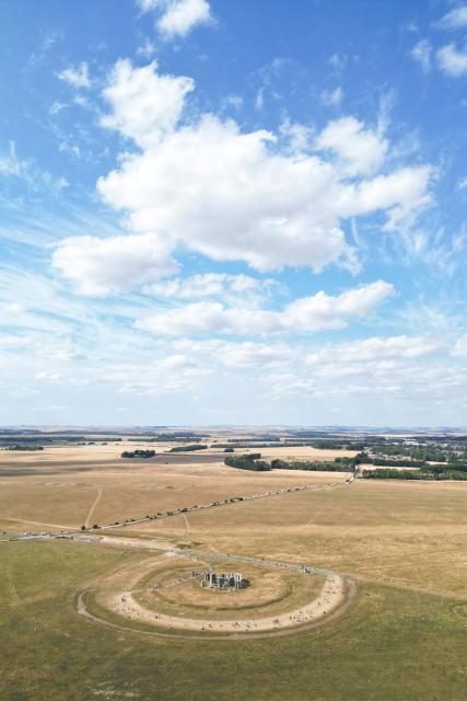 This aerial image shows the scorched grass surrounding the area at Stonehenge near Amesbury, Wiltshire in southern England on July 28, 2026. Temperatures were forecast this week to rise back into the 30s for parts of England, following three heatwaves so far over the summer. (Photo by JUSTIN TALLIS / AFP)