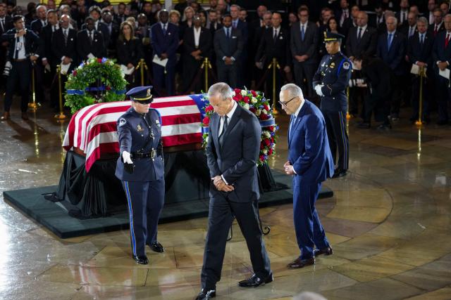 US Senate Minority Leader Chuck Schumer (D-NY) and US Senate Majority Leader John Thune (R-SD) pay their respects near the casket during a Congressional tribute to late US Senator Lindsey Graham in the Rotunda of the US Capitol in Washington, DC, on July 28, 2026. Graham, a South Carolina Republican and key Trump ally who was elected to the Senate four times, died at age 71 on July 11. (Photo by Nathan Howard / POOL / AFP)