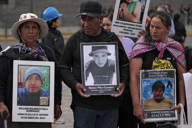Relatives of victims of crimes allegedly committed by the Peruvian state hold portraits of their loved ones during a protest outside the Palace of Justice in Lima on July 28, 2026, ahead of Peru's president-elect Keiko Fujimori's inauguration. Peru's right-wing president-elect Keiko Fujimori will take office on July 28, 2026, vowing to tackle the wave of crime sweeping the Andean nation. Fujimori won the June 7 presidential runoff by fewer than 50,000 votes, after losing the past three runoffs. (Photo by Anthony Nino de Guzman / AFP)